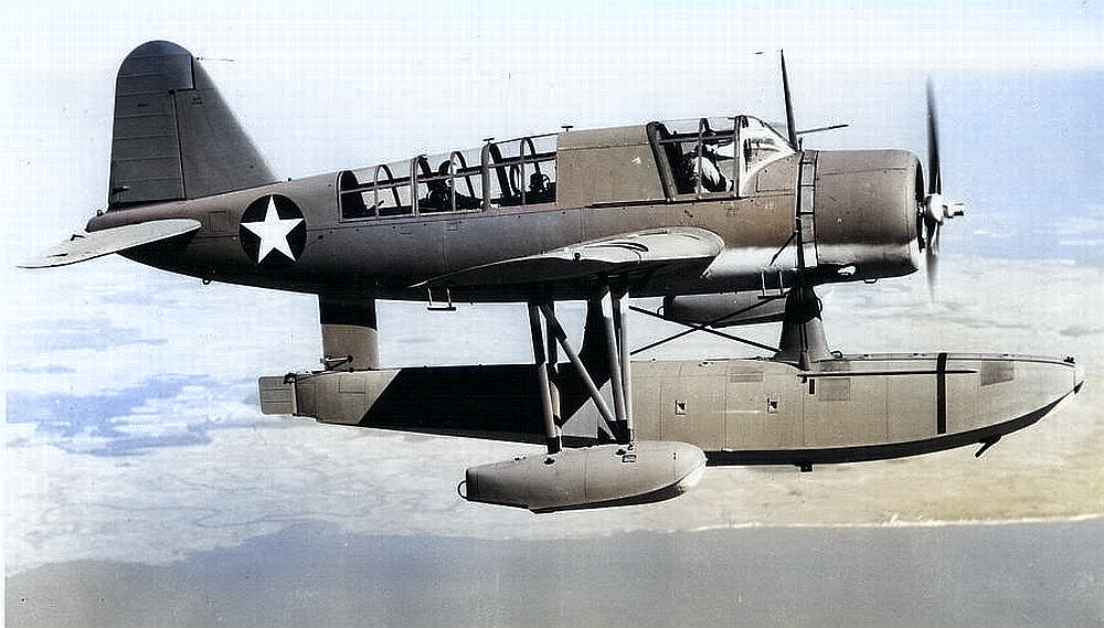 OS2N-1 Kingfisher in flight, 1942-43. [Colorized by WW2DB]