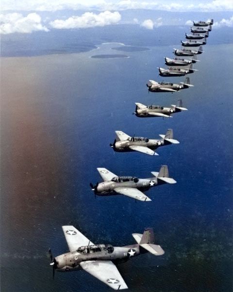 TBF-1 Avengers of Torpedo Squadron 10 from USS Enterprise fly in formation over Espiritu Santo, March 1943. [Colorized by WW2DB]