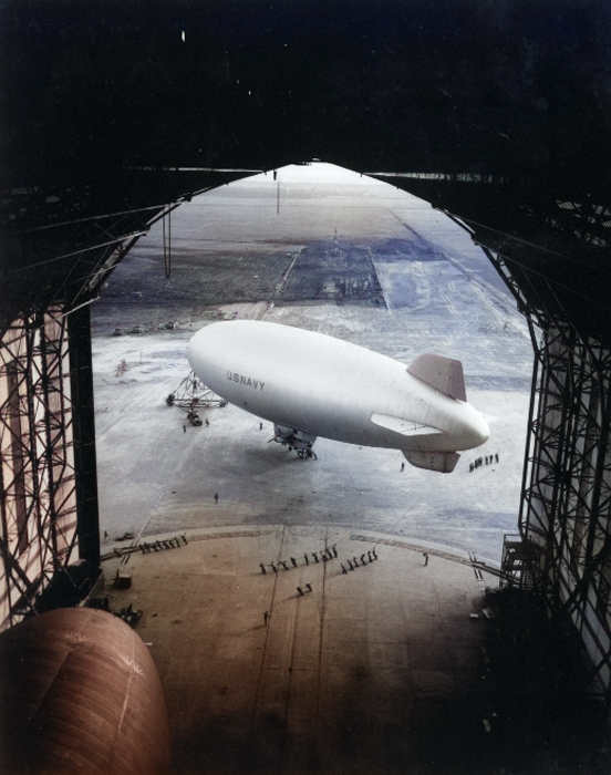 US Navy K-class airship K-84 is being moved into the hangar at Santa Cruz, Brazil, 7 Dec 1943. K-88 is seen at lower left. This hangar was originally built by Luft Hansa for the Graf Zeppelin and the Hindenburg. [Colorized by WW2DB]