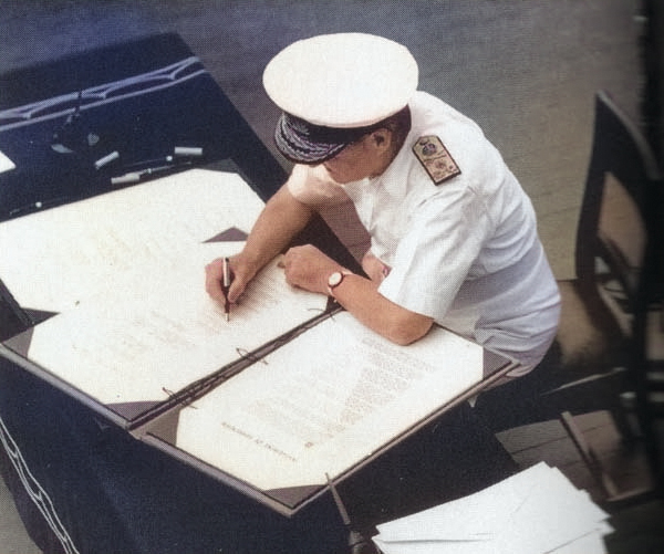 Admiral Sir Bruce Fraser signing the surrender instrument on behalf of the United Kingdom aboard USS Missouri, Tokyo Bay, Japan, 2 Sep 1945, photo 3 of 3 [Colorized by WW2DB]