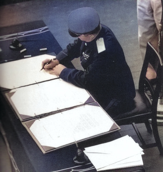 General Kuzma Nikolaivich Derevyenko signing the surrender instrument on behalf of the Soviet Union aboard USS Missouri, Tokyo Bay, Japan, 2 Sep 1945, photo 2 of 2 [Colorized by WW2DB]