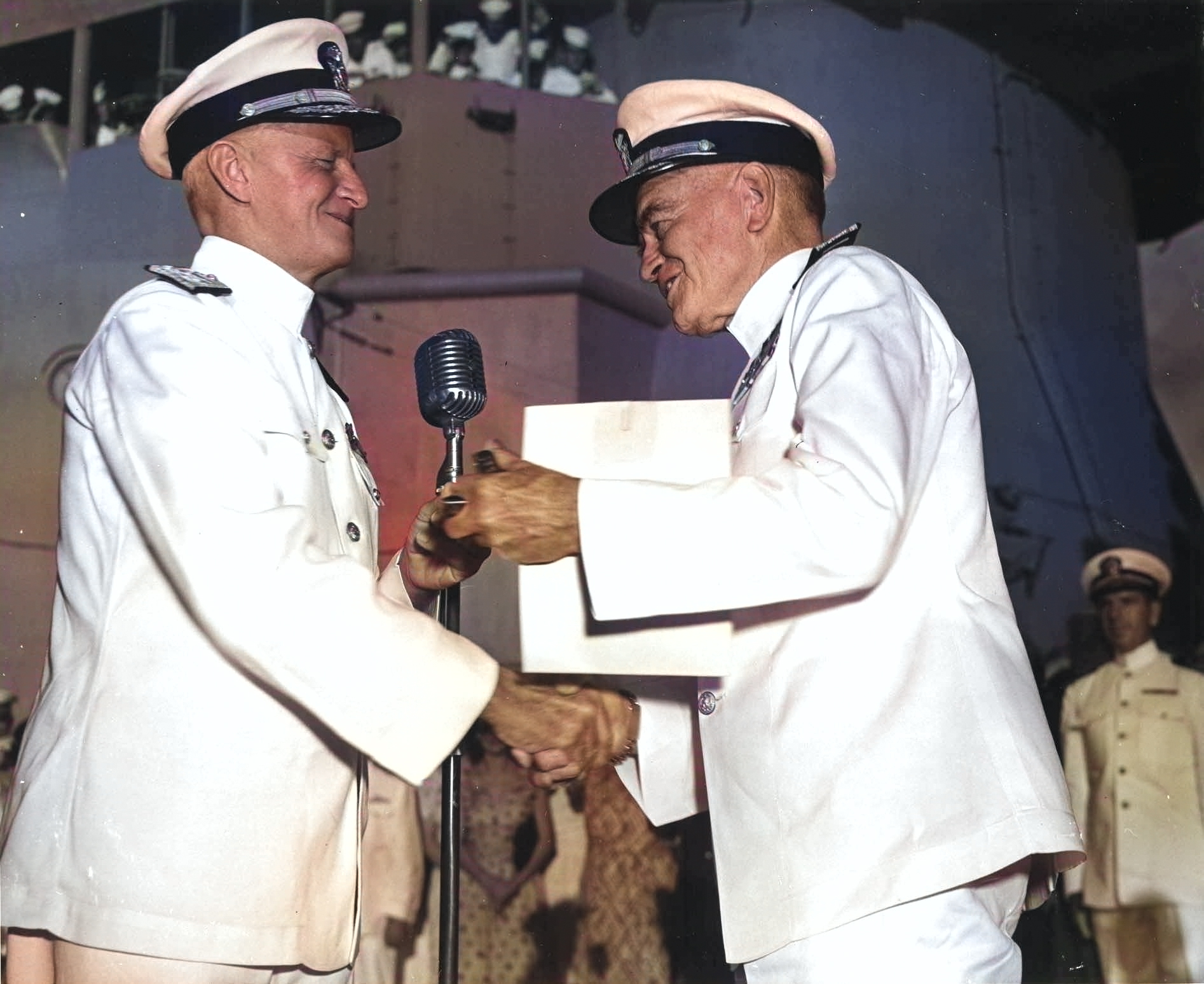 Fleet Admiral Chester Nimitz presenting Admiral William Halsey with a gold star in lieu of a fourth award of the Navy Distinguished Service Medal aboard USS Missouri in Pearl Harbor, 28 Sep 1945. [Colorized by WW2DB]