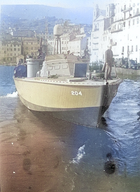 PT-204, a Higgins 78-footer of Motor Torpedo Boat Squadron 15 (MTBRon 15) in Bastia harbor, Corsica, France, May 1944. [Colorized by WW2DB]