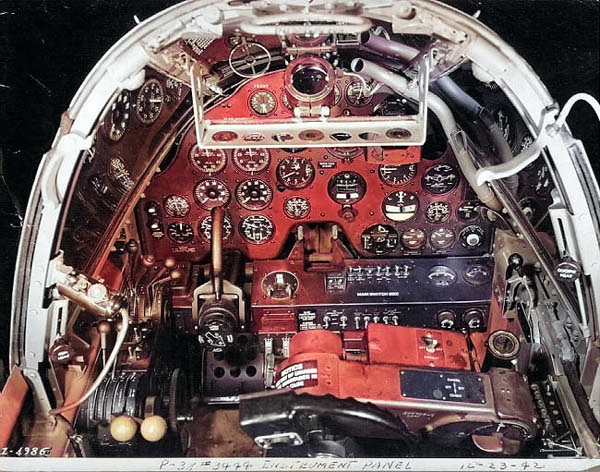 Close-up view of a P-38G Lightning aircraft cockpit, 23 Dec 1942; note the yoke rather than stick control and the bullet proof glass panel above the instrument panel. Photo 2 of 3. [Colorized by WW2DB]