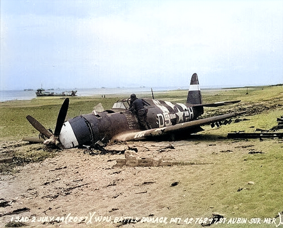 2 Jul 1944 photo of the wreckage left on Sword Beach following the D-Day landings in Normandy, France; in this case, a P-47 Thunderbolt that was shot down 10 Jun 1944 on a mission to Cherbourg, France. Photo 1 of 2. [Colorized by WW2DB]