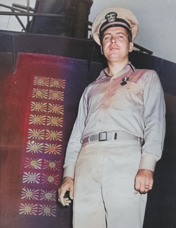 Lieutenant Commander Roy Davenport posing beside USS Haddock's conning tower, 10 Nov 1943 [Colorized by WW2DB]