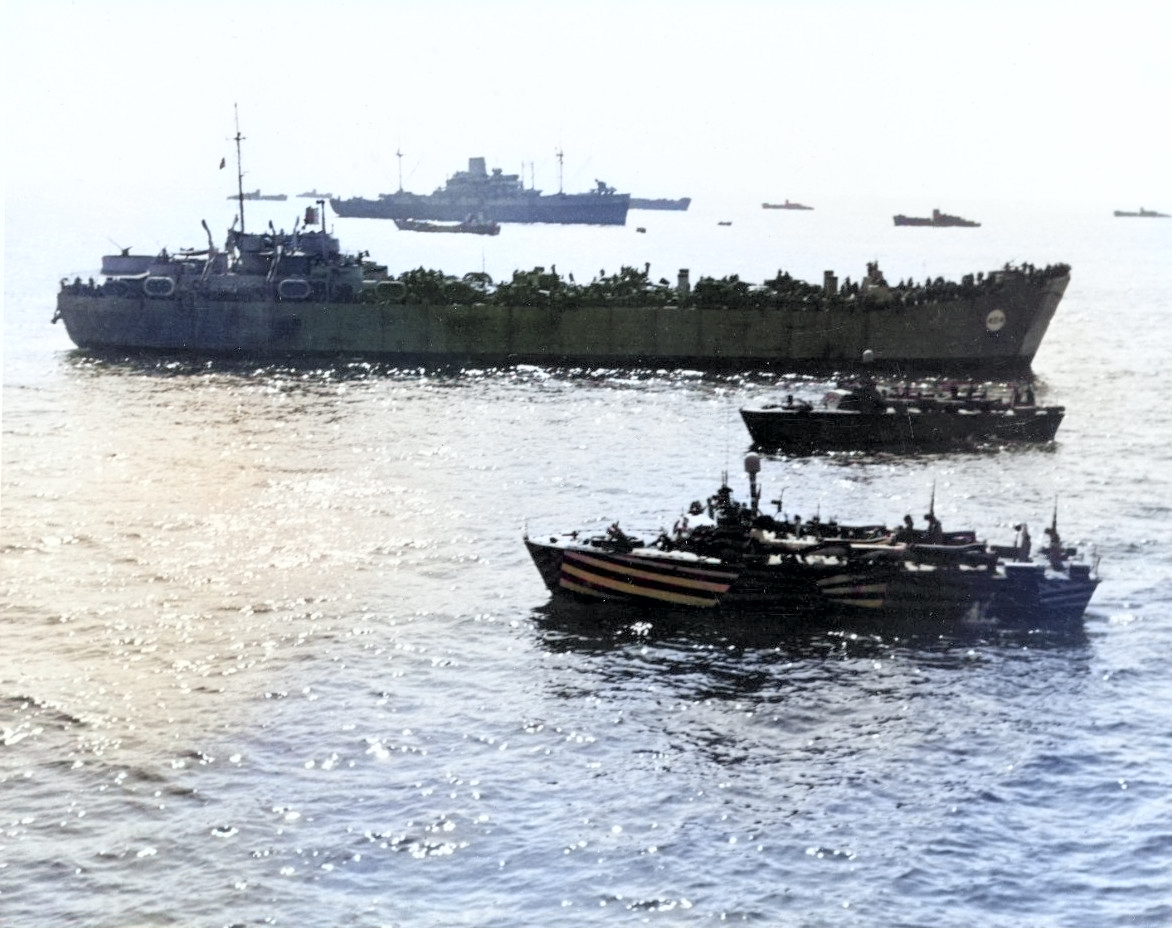 USS Ancon (background), HM LST-404, and other ships off Salerno, Italy, 12 Sep 1943 [Colorized by WW2DB]