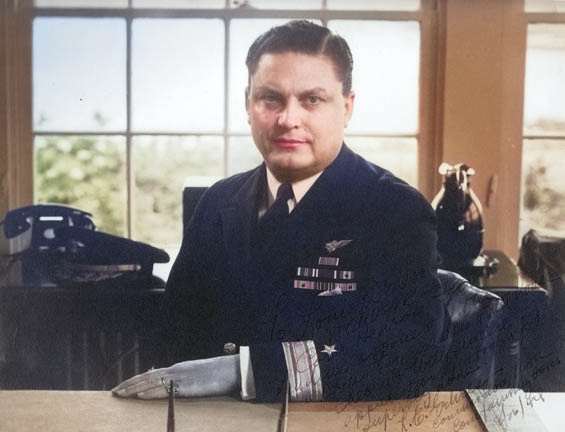 Portrait of Commodore Leslie Gehres sitting at his desk as commander of Fleet Air Wing Four, Adak, Alaska, mid-1944. [Colorized by WW2DB]