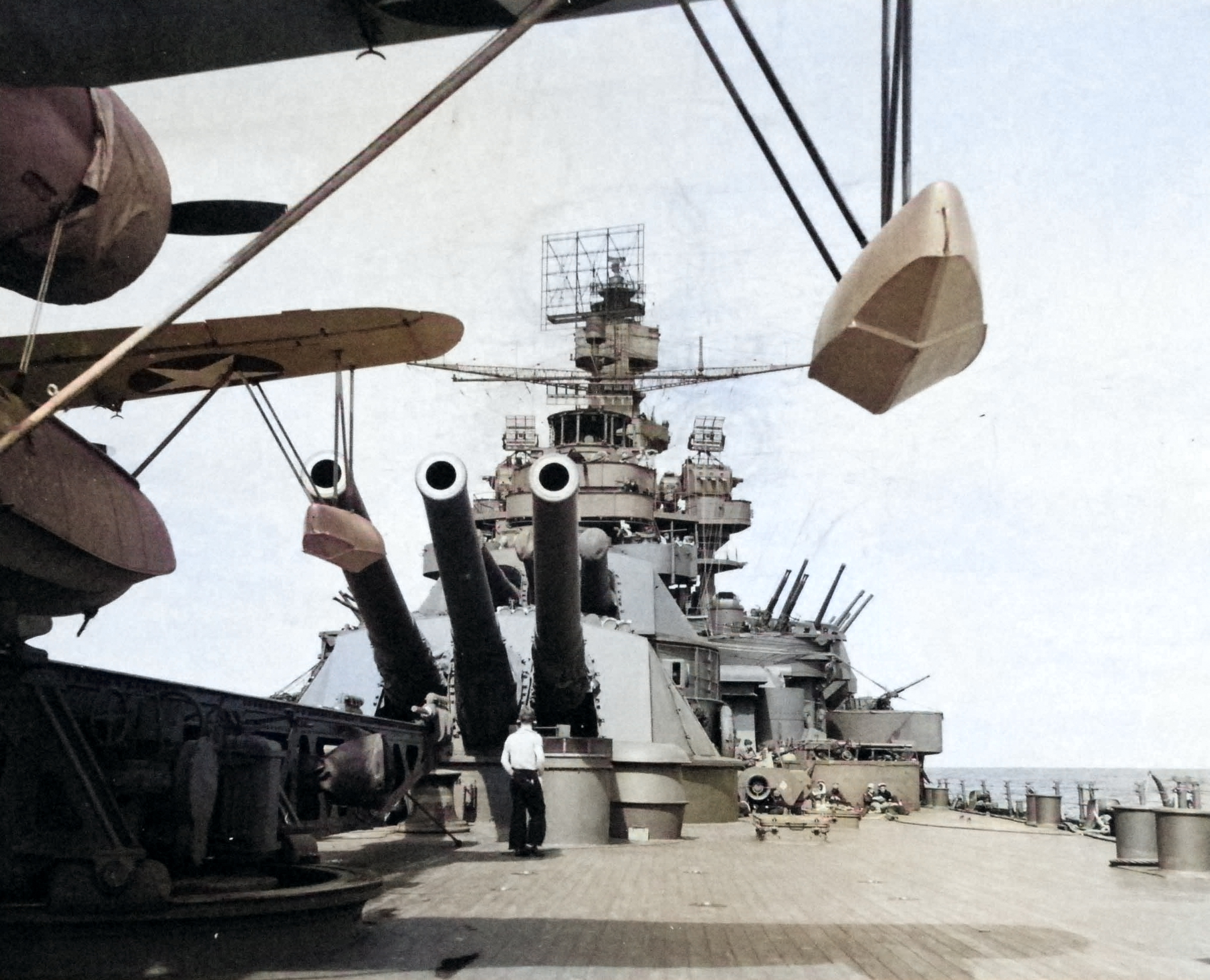 USS Pennsylvania’s #4 main battery seen from under the wing of an OS2U Kingfisher catapult scout plane as the battleship is preparing for the bombardment of Attu Island in the Aleutians, 11 May 1943. [Colorized by WW2DB]
