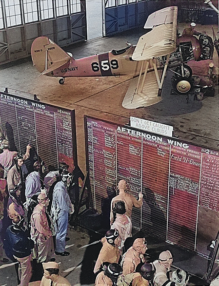 US Navy aviation cadets check flight boards for last minute instructions, Naval Air Training Center, Naval Air Station Corpus Christi, Texas, United States, Nov 1942; note N3N-3 Canary aircraft [Colorized by WW2DB]