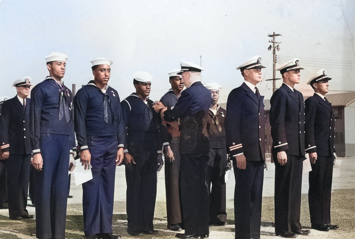 Rear Admiral Carlton H. Wright pinning the Navy and Marine Corps Medal on Seaman 1st-class James A. Camper, Jr. for heroism displayed following the Port Chicago munitions explosion 17 Jul 1944. 26 Oct 1944 photo. [Colorized by WW2DB]