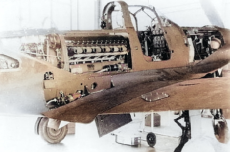 P-39 Airacobra aircraft with maintenance panels open, revealing the engine and other internal workings, date unknown [Colorized by WW2DB]