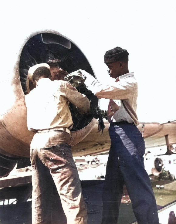 Mechanics working on a PBY Catalina engine at Naval Air Station, Seattle, Washington, 26-27 Apr 1944 [Colorized by WW2DB]