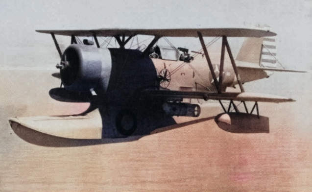 US Navy J2F-5 Duck aircraft in flight during anti-submarine patrol, 23 Apr 1942; note Mark XVII depth charges [Colorized by WW2DB]