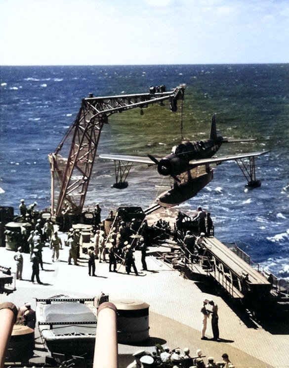 Crew of Battleship Missouri recovering an OS2U Kingfisher aircraft, circa Aug 1944 [Colorized by WW2DB]