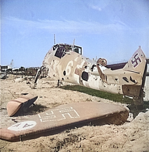 A wrecked German Bf 109 fighter, El Aouiana airfield, Tunisia, circa May-Jun 1943 [Colorized by WW2DB]