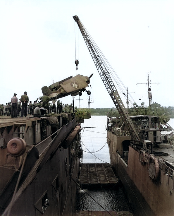 A Wildcat lifted from APV Kitty Hawk to ACV Long Island, Fila Harbor, New Hebrides (now Port Vila, Vanuatu), 28 Aug 1942 [Colorized by WW2DB]