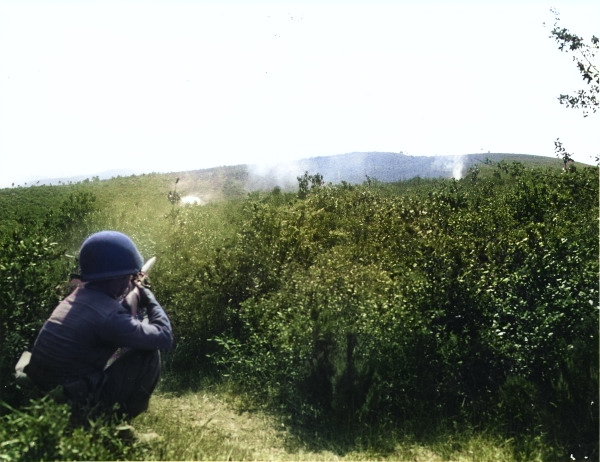 Japanese-American soldier of 100th Infantry Battalion, US 442nd Regimental Combat Team firing his M1 Garand rifle at a suspected German sniper position, Montenero area, Italy, 7 Aug 1944 [Colorized by WW2DB]