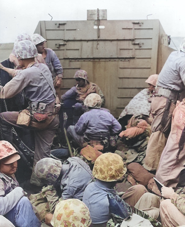 Marines crouched in a Coast Guard-manned LCVP on the way in on the first wave to hit the beach at Iwo Jima, 19 Feb 1945, photo 2 of 2 [Colorized by WW2DB]