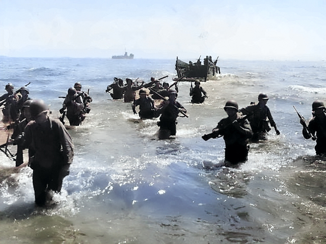 First wave of American troops storming ashore from amphibious landing craft, Leyte, Philippine Islands, 20 Oct 1944, photo 1 of 3 [Colorized by WW2DB]