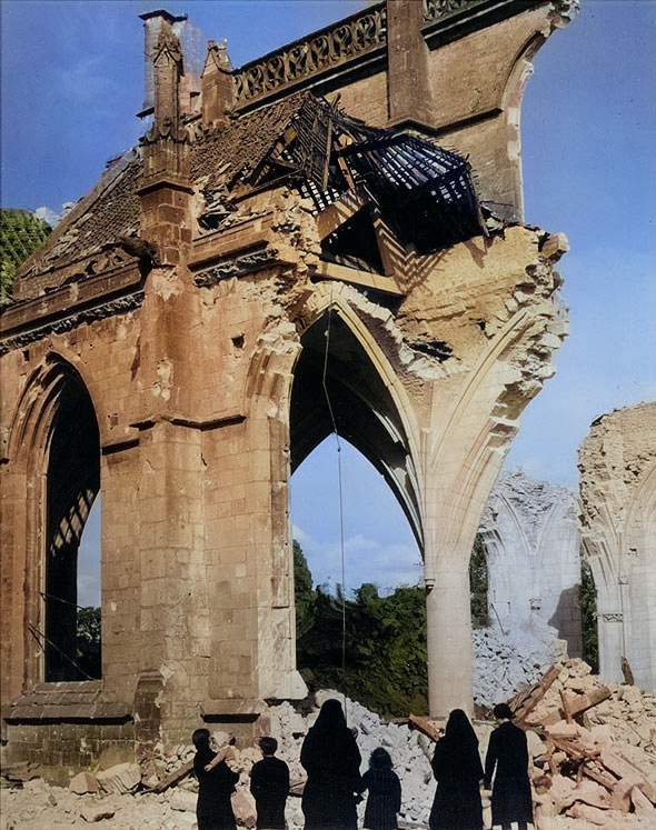 Two Nuns and a French family examined the ruins of the bombed Église Saint-Malo, Valognes, France, Jul 1944 [Colorized by WW2DB]