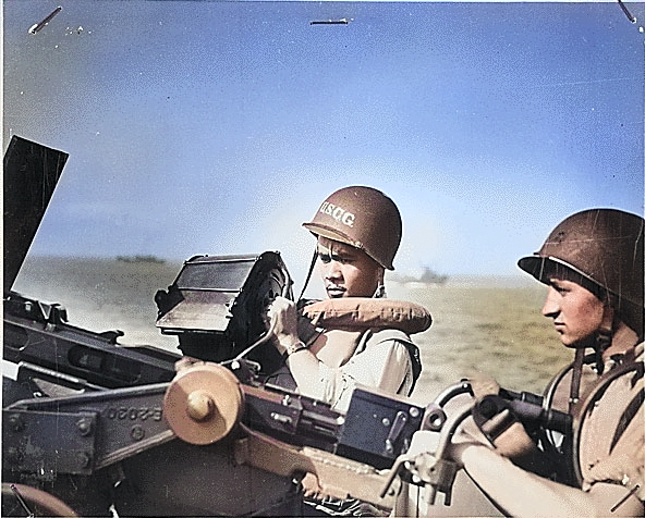 Two Ohio United States Coast Guard men, John R. Smith and Daniel J. Kaczorowski, at their gun aboard a transport off Normandy, circa Jun 1944 [Colorized by WW2DB]