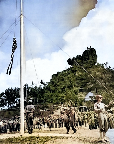 Raising the US flag on Okinawa, Japan, 22 Jun 1945 [Colorized by WW2DB]