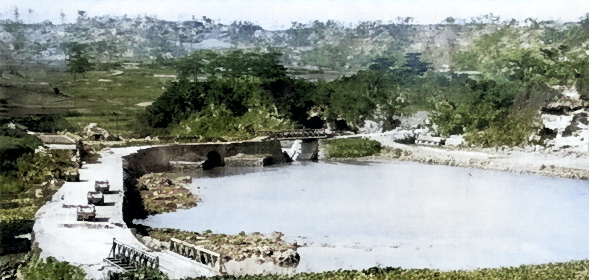 Machinato Inlet immediately after combat, Okinawa, Japan, 19 Apr 1945; note wrecked M29 Weasel vehicles on the road [Colorized by WW2DB]