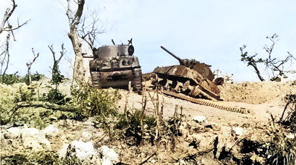 Two wrecked M4 Sherman tanks at Bloody Ridge, destroyed by Japanese artillery, Okinawa, Japan, 20 Apr 1945 [Colorized by WW2DB]