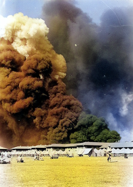 View of the Parade Ground at the Pearl Harbor Marine Barracks, between 0930 and 1130 on 7 Dec 1941, with smoke in the background rising from burning ships, photo 2 of 3 [Colorized by WW2DB]