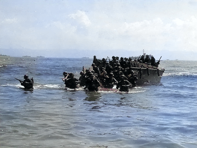 First wave of American troops storming ashore from amphibious landing craft, Leyte, Philippine Islands, 20 Oct 1944, photo 2 of 3 [Colorized by WW2DB]