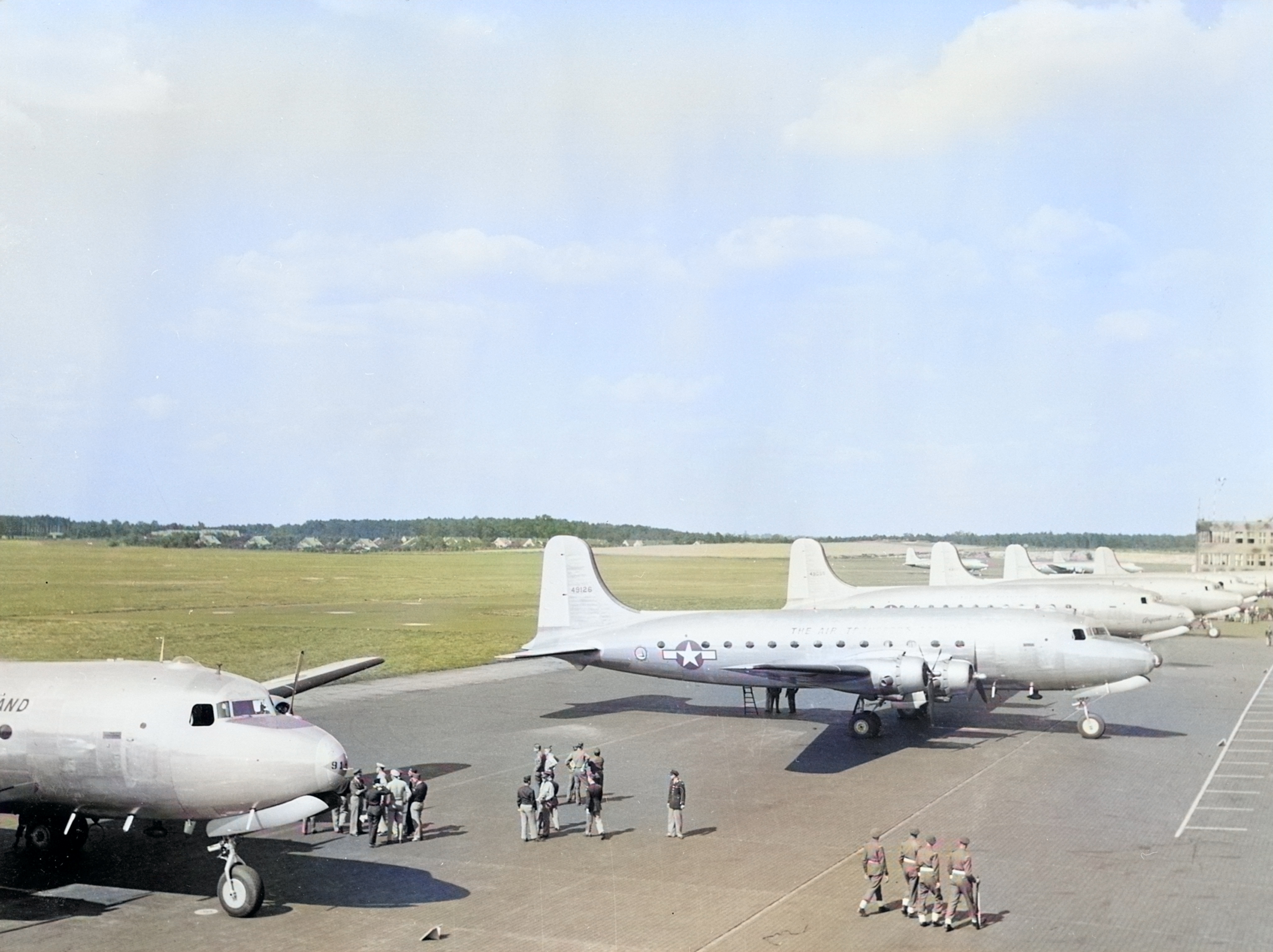US C-54 Skymaster aircraft at the Berlin-Gatow airfield, Germany, 15 Jul 1945; these aircraft brought Harry Truman and other US leaders to Berlin for the Potsdam Conference [Colorized by WW2DB]