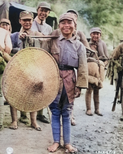 Chinese boy hired to assist troops of Chinese 39th Division during the Salween Offensive, Yunnan Province, China, 1944 [Colorized by WW2DB]