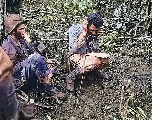 US Marine battalion commanding officer Lieutenant Colonel John Weber receiving a report from a company commander, Cape Gloucester, New Britain, Bismarck Archipelago, Jan 1944 [Colorized by WW2DB]