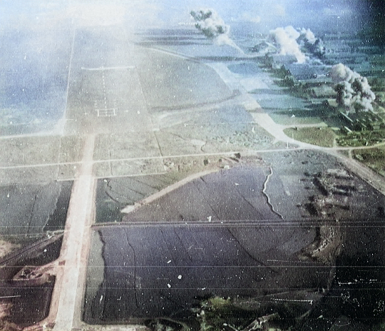 Kagi Airfield under carrier aircraft attack, Taiwan, 12 Oct 1944, photo 5 of 5 [Colorized by WW2DB]