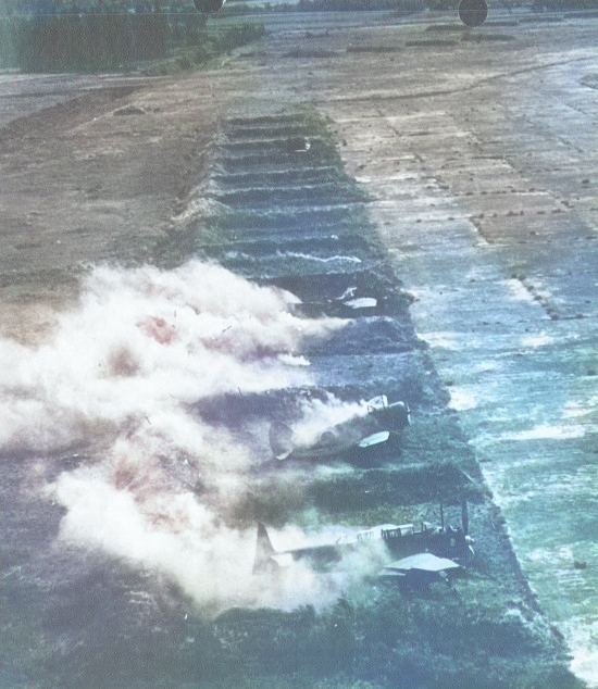 Decoy Japanese B6N, Ki-27, and other aircraft emitting false smoke during US air raid, Koshun Airfield, southern Taiwan, date unknown [Colorized by WW2DB]