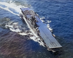 Aerial view of Yorktown (Essex-class) with F6F Hellcat fighters, Apr-May 1944. Note opposite facing fore and aft deck numbers that were quickly corrected. The dark stripe down the flight deck was unique to Yorktown