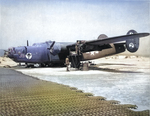 Maintenance crews work on an engine swap on a B-24H Liberator at San Pancrazio Airfield, southern Italy, early 1944.