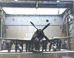 A P-47D Thunderbolt of the 318th Fighter Group is loaded into an Escort Carrier hangar bay by way of the aircraft elevator, Pearl Harbor, Hawaii, June 1944. The Fighter Group was on its way to Saipan, Marianas.