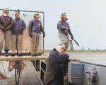 The training aircraft carrier USS Sable trained many Landing Signal Officers (LSOs) as well as pilots, Lt Whitaker seen here with the flags.  Lake Michigan, United States, May 1945.