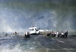 Deck crews aboard the training aircraft carrier USS Sable man lines to right an FM-2 Wildcat that had nosed completely over. Lake Michigan, United States, 1943-45. Photo 1 of 3.