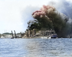 USS Shaw burning in partially sunk Floating Drydock YFD-2, Pearl Harbor, Oahu, Hawaii, Dec 7, 1941. Note men at left playing fire hoses in the direction of the drydock.