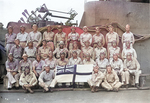 US Navy pilots of Fighting Squadron 6 display the Royal Navy Ensign and the crest of HMS Victorious during their service aboard the British carrier when she was on loan to the US Fleet, 1943.