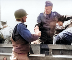 US Army Chief of Staff, Gen George Marshall shakes hands with another officer during his tour of the Normandy beachhead, Normandy, France, Jun 12, 1944.  Note Gen Eisenhower behind Marshall.