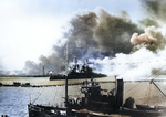 USS Nevada passes the drydocks on her attempted sortie as seen from Ford Island. USS Avocet is at the bottom and the dredge line from the dredge ‘Turbine’ in between, Pearl Harbor, Oahu, Hawaii, Dec 7, 1941.