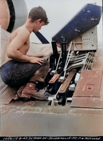 Marine Pfc C.H. McClure servicing the three Browning M2 .50 caliber machine guns in the right wing of an F4U-1 Corsair fighter on Bougainville, Dec 9, 1943