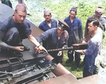 US Navy officers train in ordnance maintenance at Jacksonville, Florida, United States, Jul 12, 1944. In this case, they are installing a Browning M2 .50 caliber machine gun into the right wing of an F4U Corsair fighter.