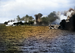 Escort Carrier USS Gambier Bay, Destroyer Escort USS Raymond, and another Destroyer Escort, elements of Taffy 3, laying smoke before engaging the Japanese Center Force in the Battle Off Samar, Oct 25, 1944.