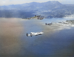 USAAF Photo Reconnaissance F-5E Lightning ‘Information Please’ accompanying Marine F4U Corsairs on a raid to Kushi-Take, Okinawa, Japan, June 1945. Photo 1 of 2. Note the photo nacelle under the F-5.