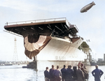 Essex-class aircraft carrier USS Bunker Hill just after launching at the Fore River yards, Quincy, Massachusetts, United States, Dec 11, 1942. Note K-class airship from Airship Patrol Squadron ZP-11 overhead.